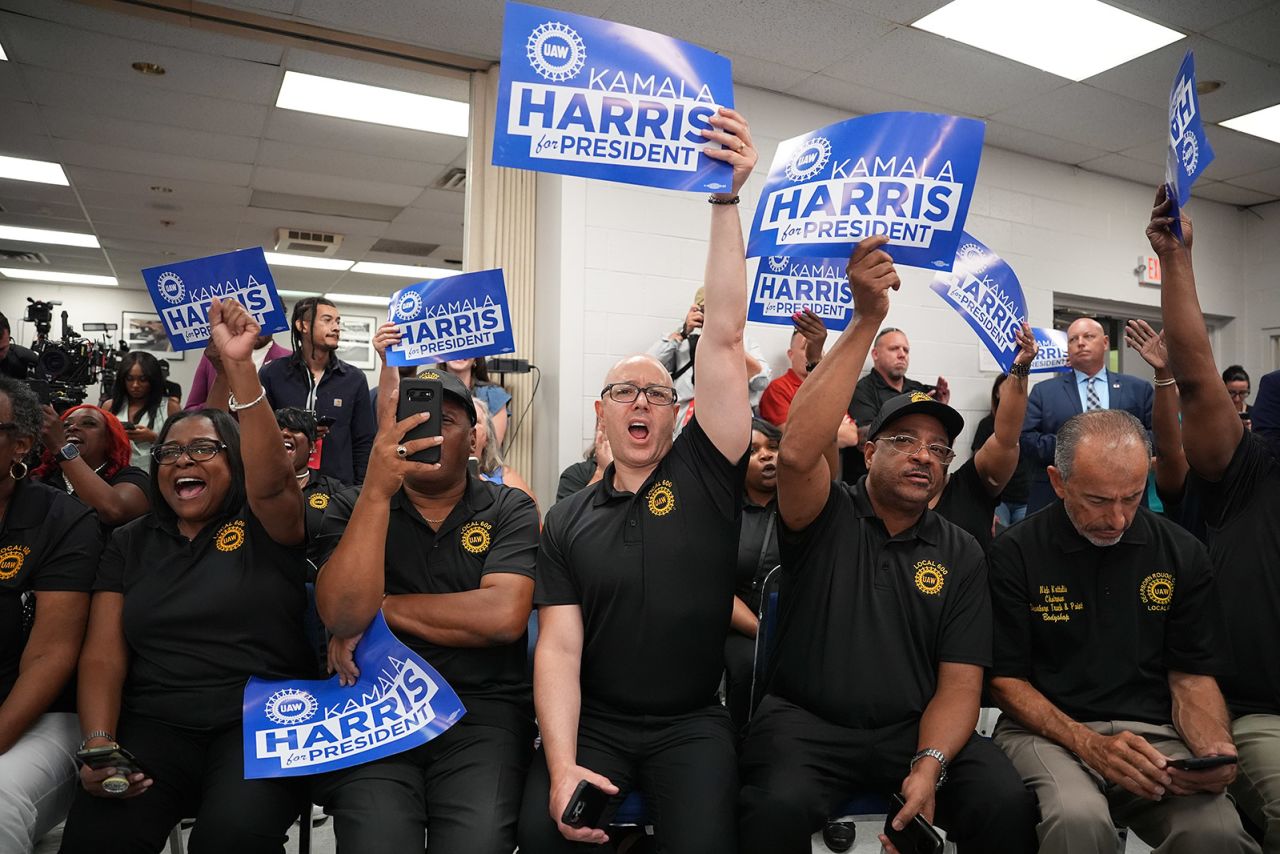 Audience members cheer as Democratic presidential candidate Vice President Kamala Harris and Democratic vice presidential candidate Minnesota Gov. Tim Walz appear at a campaign rally at United Auto Workers Local 900 in Wayne, Michigan on August 8.