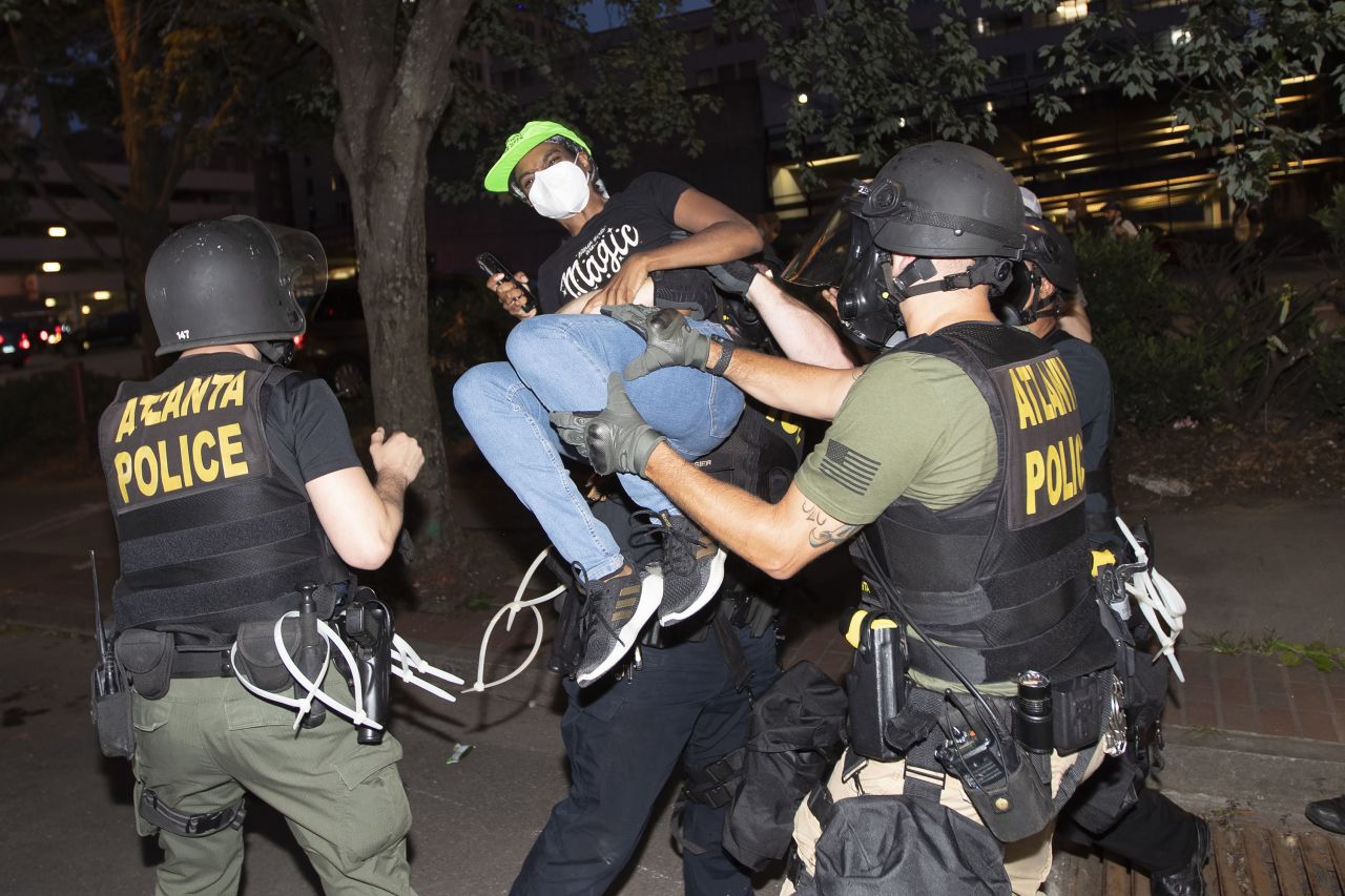 A protester is taken into custody by Atlanta police during a demonstration Monday, June 1, 2020, in Atlanta over the death of George Floyd, who died May 25 after being restrained by Minneapolis police. (AP Photo/John Bazemore)