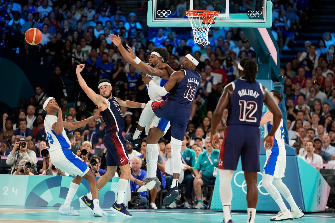 Frances's Bilal Coulibaly, Devin Booker of Team USA, Guerschon Yabusele of France and the United States' Bam Adebayo battle for possession. 