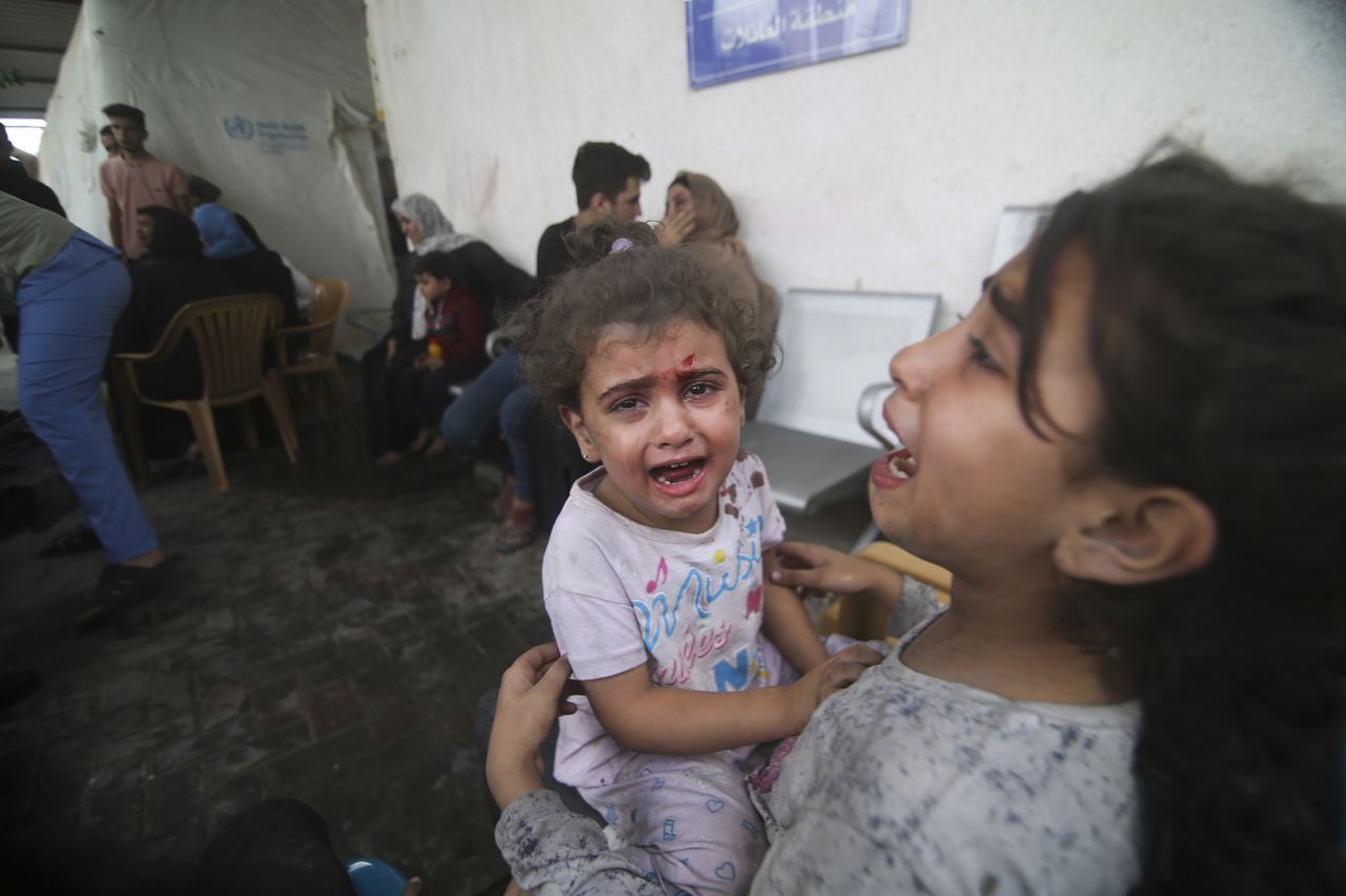 Palestinian children wounded in Israeli strikes attend a hospital in Rafah refugee camp, southern Gaza Strip, on October 12.