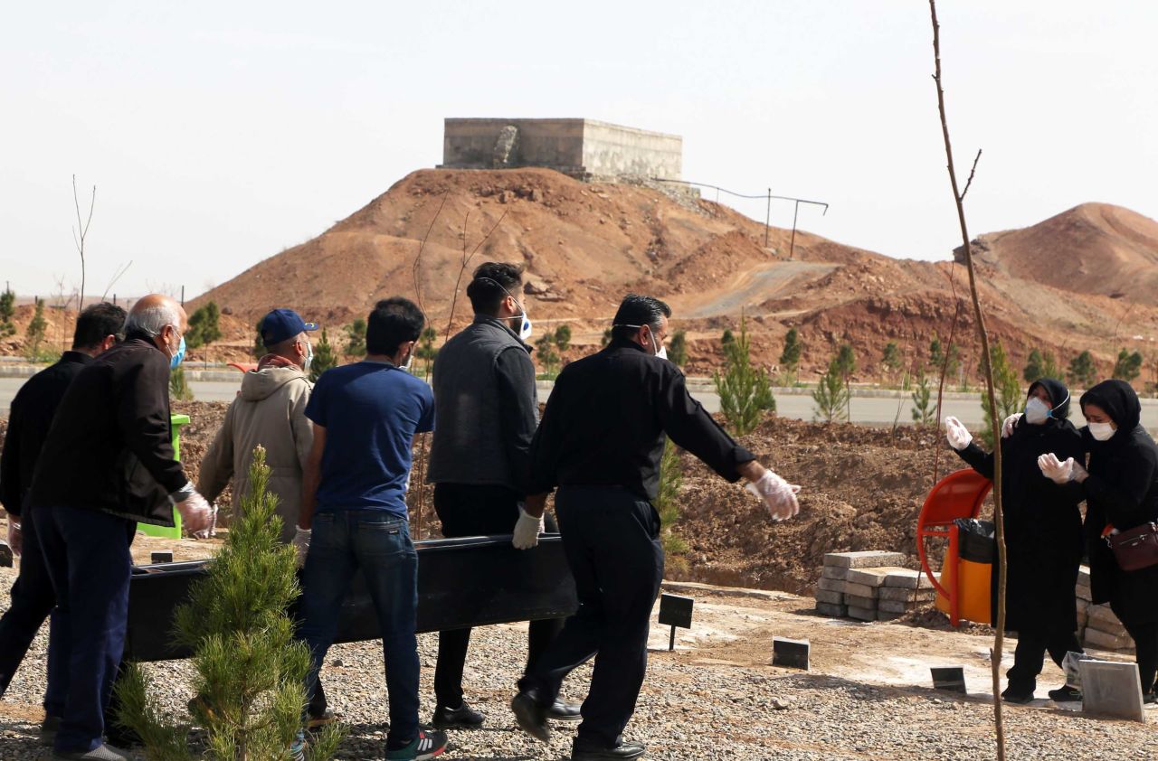 People carry the coffin of a coronavirus victim at Beheshte Masoumeh Cemetery in Qom, Iran on March 17.