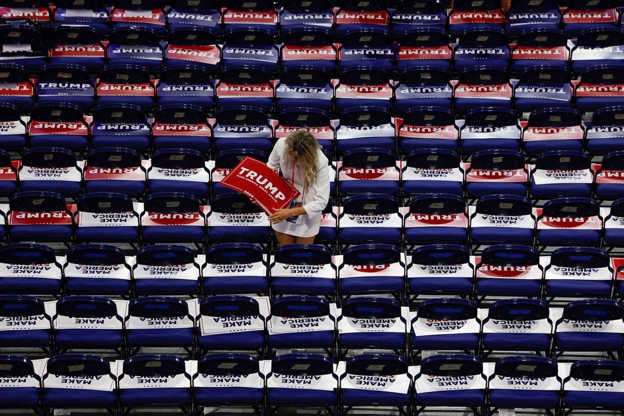 An attendee puts out signs in support of Republican presidential nominee and former US President Donald Trump ahead of Day 3 of the Republican National Convention in Milwaukee, Wisconsin, on Wednesday, July 17. 