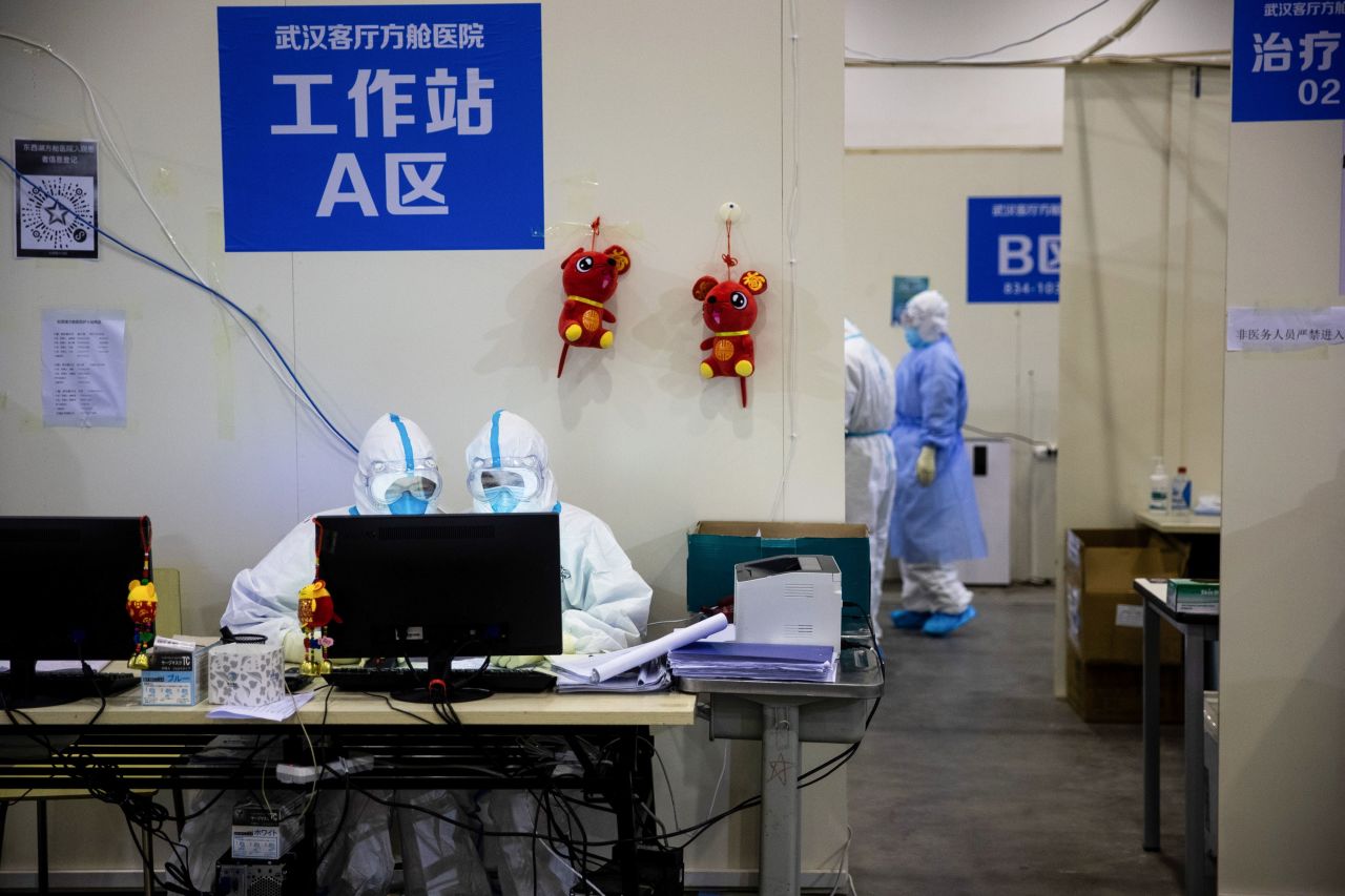 Medical staff members in protective gear work at the converted hospital in Wuhan. 