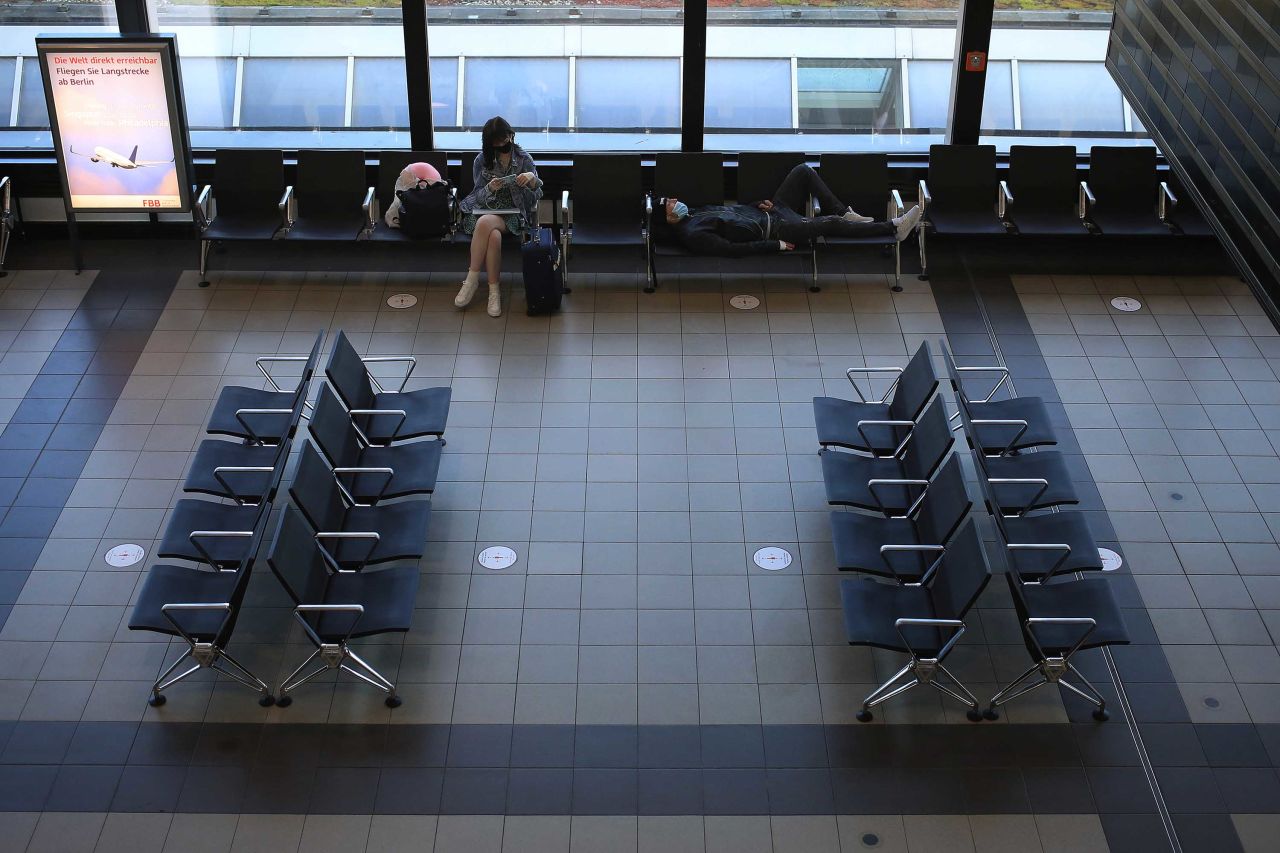 Travelers wait in a departure lounge at Berlin Shoenfeld Airport on June 15.