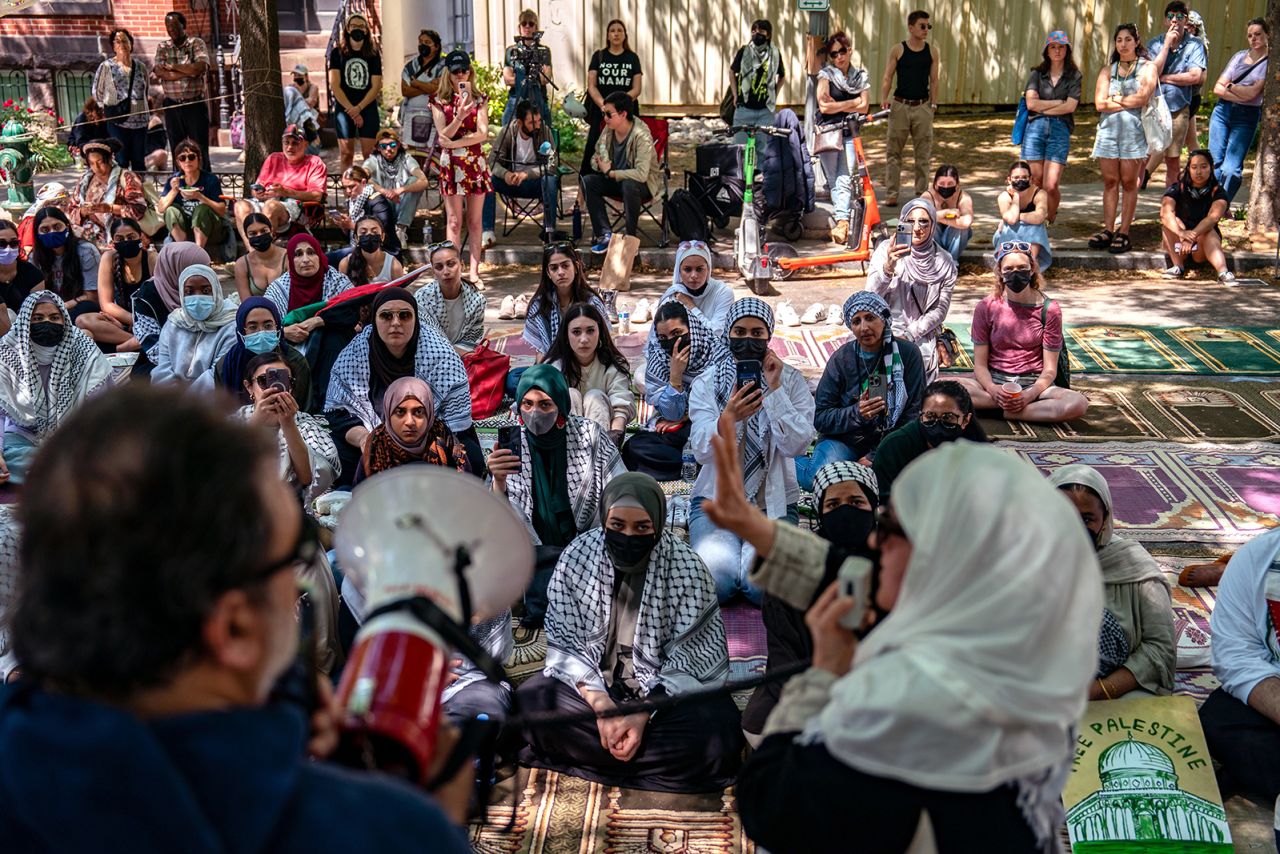 People sit to listen as activists and students protest near an encampment at University Yard, George Washington University on April 28, in Washington, DC. 