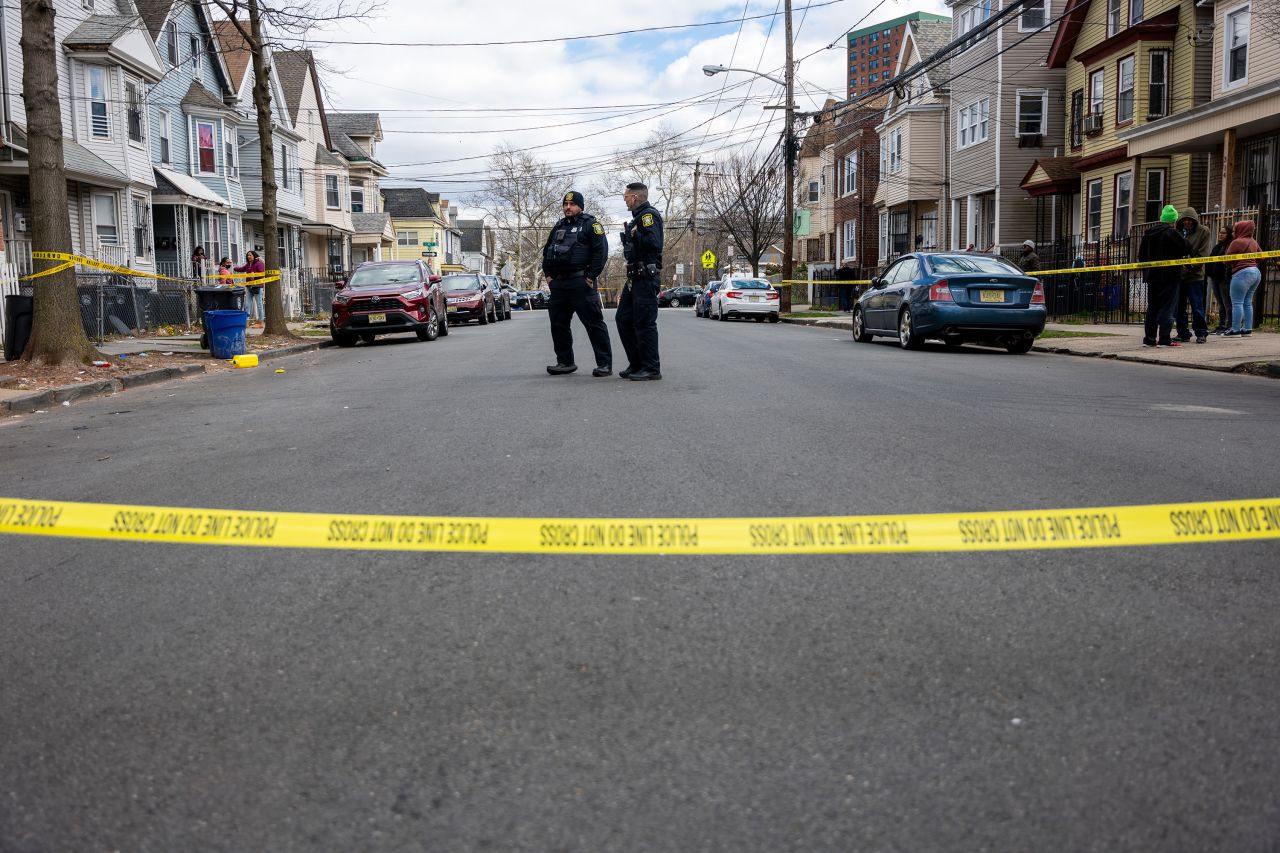 Residents and police gather outside of Newark, New Jersey, homes that were structurally damaged and had to be evacuated after an earthquake Friday. 