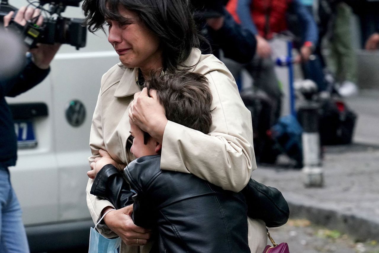 A parent escorts her child following the shooting at Vladislav Ribnikar elementary school in Vračar, an upscale area of the Serbian capital.
