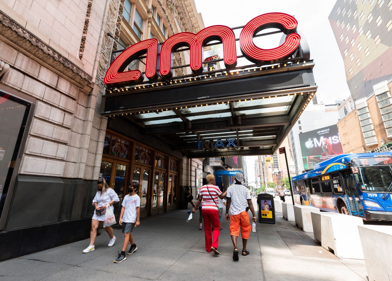 People walk by an AMC movie theater in Times Square on June 8, in New York City. 