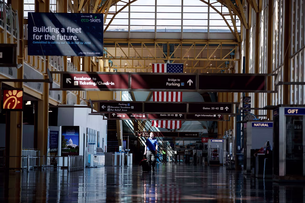 A person walks through a nearly empty terminal at Ronald Reagan Washington National Airport on March 30.
