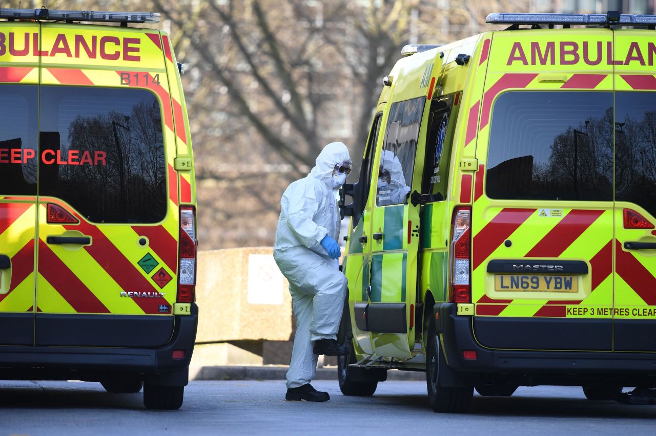 A member of the ambulance service transports a patient into an ambulance at St Thomas' Hospital in London on March 24.