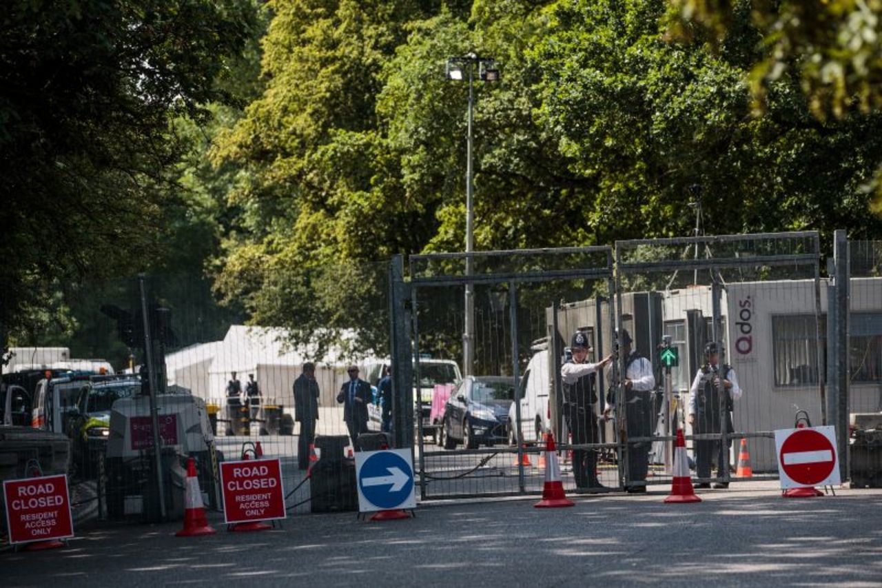 Police officers stand behind security fencing around Winfield House, the London residence of US ambassador Woody Johnson.