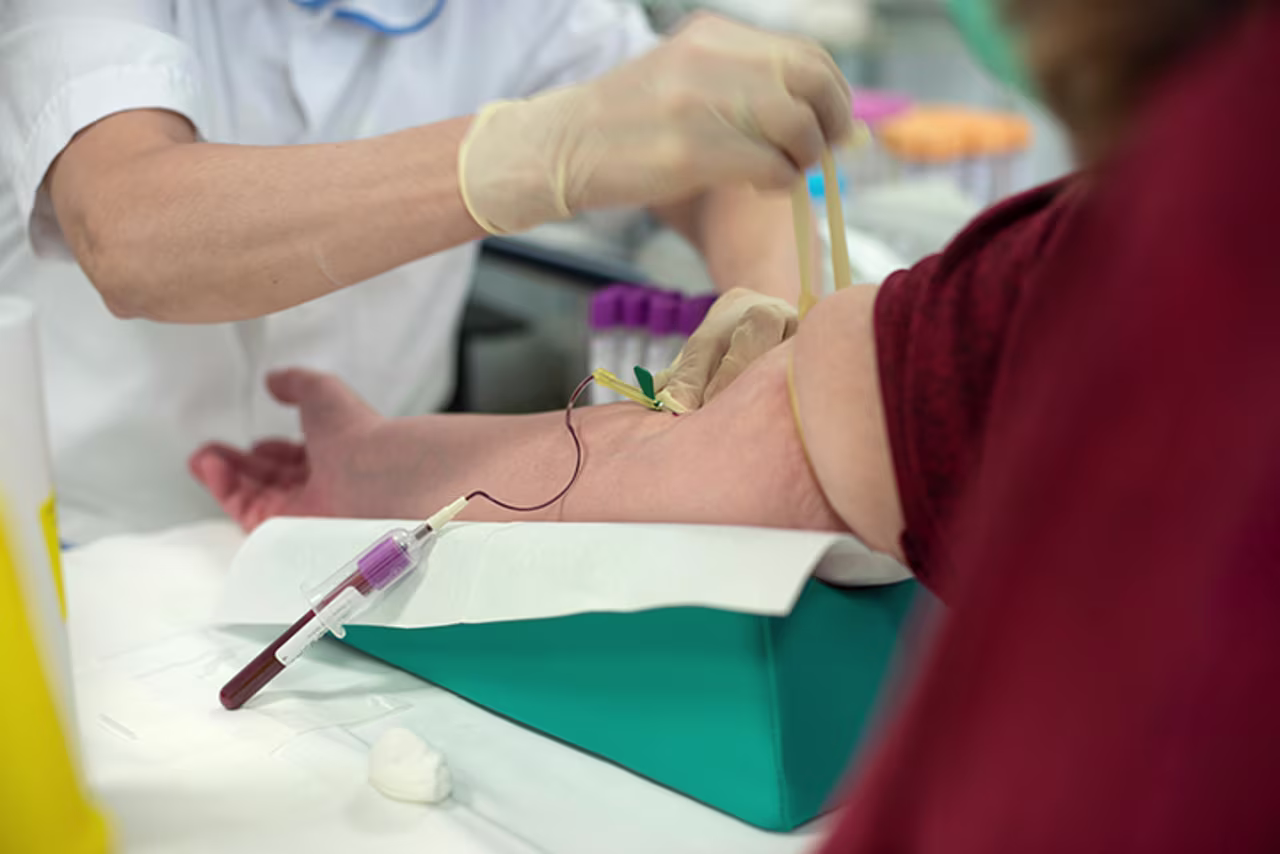 A health care worker performs a serological test at Bellaria Hospital, where coronavirus swabs and serological tests are carried out to map the contagion, on Monday, April 20, in Bologna, Italy. 