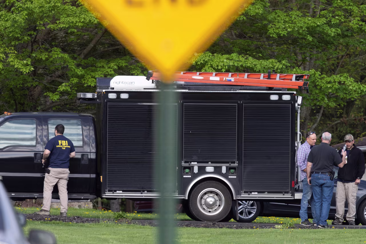 Law enforcement personnel are seen at the home of Buffalo supermarket shooting suspect Payton Gendron in Conklin, New York on May 15.