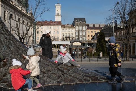 Children play by the monument to Ukrainian poet Taras Shevchenko in Lviv on Sunday. 