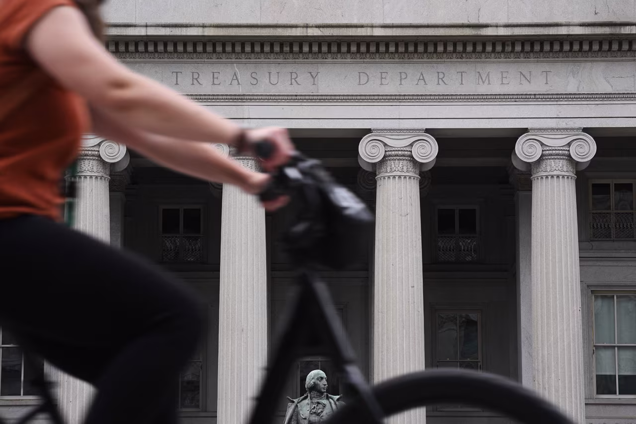People pass by the Treasury building in Washington, DC, on May 19.