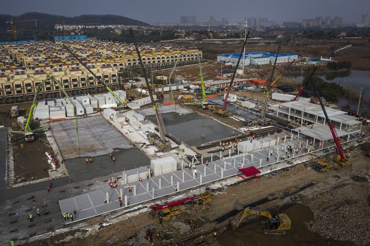 Hundreds of construction workers and heavy machinery build the Wuhan Huoshenshan hospital to tackle the coronavirus on January 28.