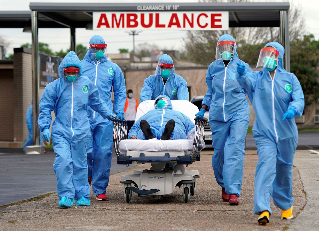 Medical workers take a patient on a gurney into United Memorial Medical Center in Houston, Texas, on March 19.