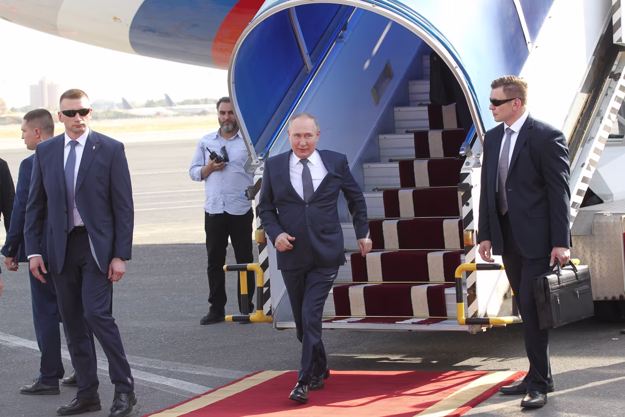 Russian President Vladimir Putin leaves his presidential plane during the welcoming ceremony at the airport, on July 19, in Tehran, Iran. 