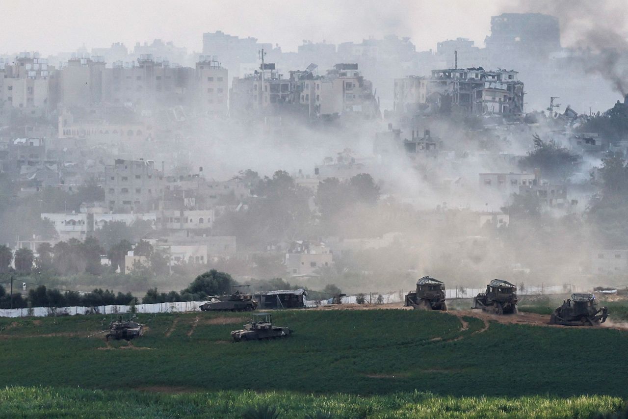 Israeli tanks and other military vehicles maneuver inside Gaza, as seen from Israel, on October 29.