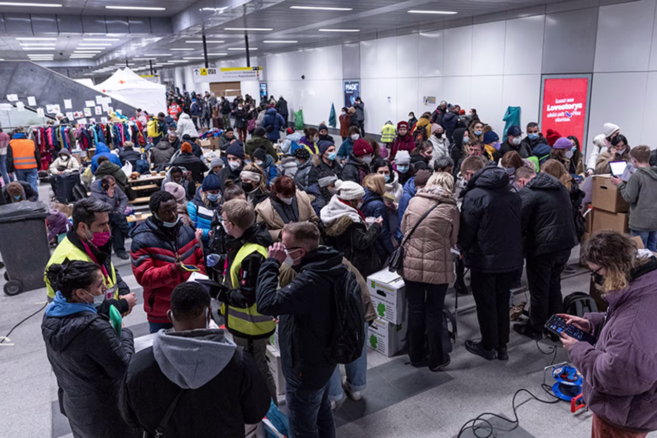 People fleeing Ukraine receive help from volunteers as they arrive on a train from Poland at Hauptbahnhof main railway station on Friday, March 4, in Berlin, Germany. 