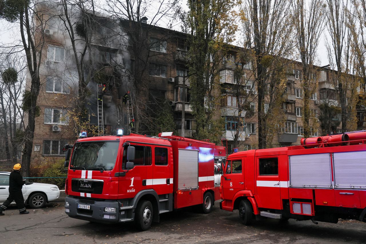 Firefighters work to put out a fire in a residential building hit by a Russian strike in Kyiv, Ukraine, on November 15.