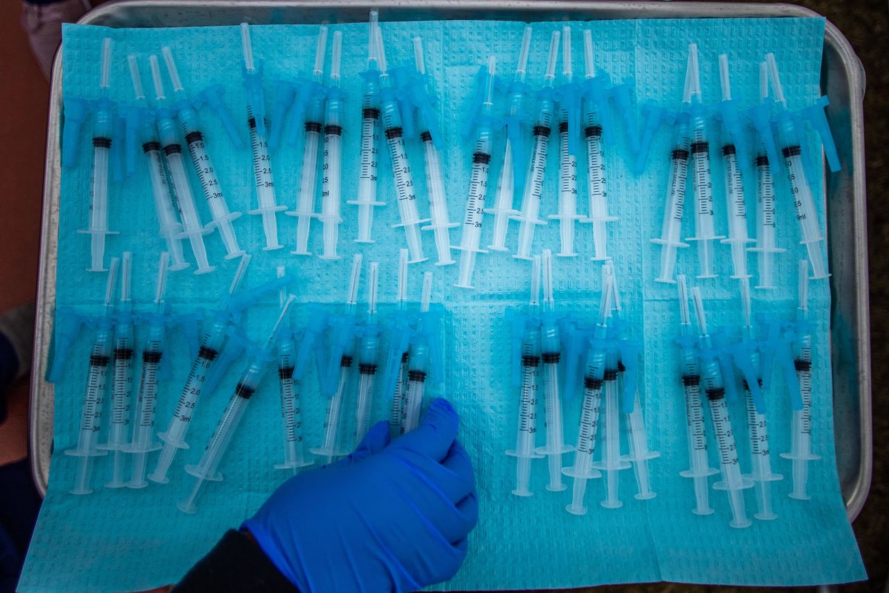 A nurse picks up a Moderna Covid-19 vaccine that is ready to be administered at a vaccination site at Kedren Community Health Center in Los Angeles on February 16.