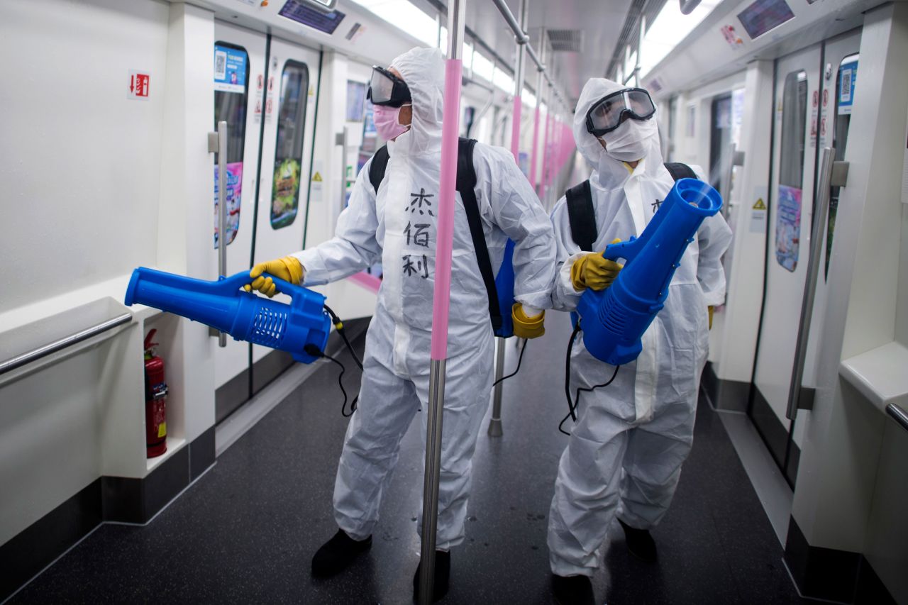 Workers disinfect a subway train on March 23 in preparation for the restoration of public transport in Wuhan, China.