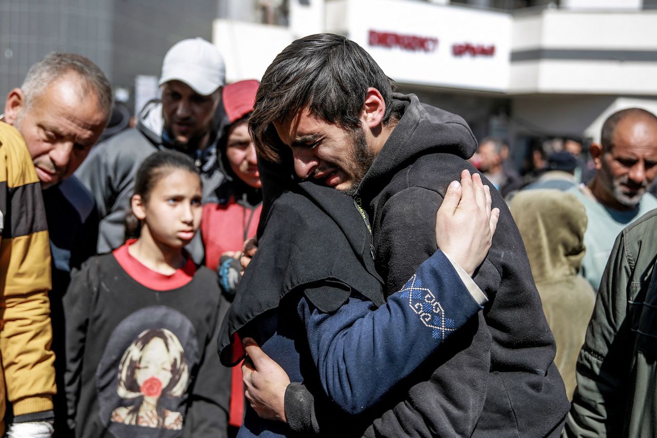 People mourn following an early morning incident when Israeli forces opened fire on crowds rushing at an aid distribution point in Gaza on February 29.