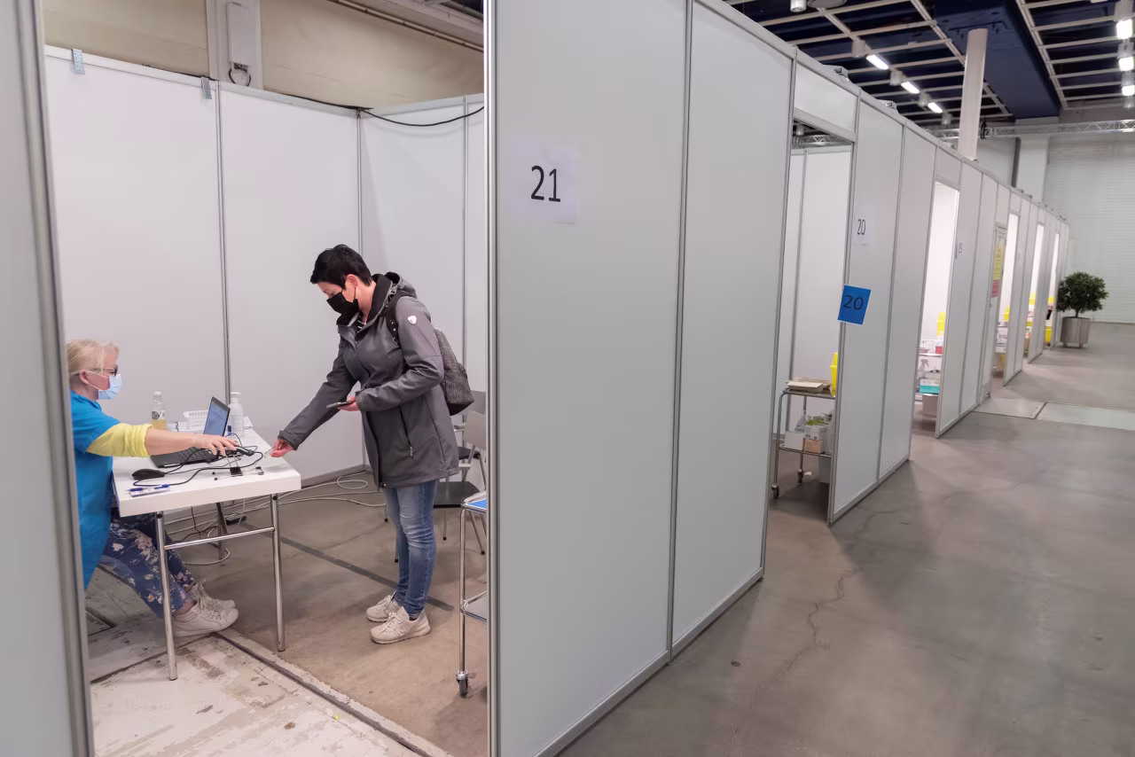 A healthcare worker prepares to administer a dose of covid-19 vaccine to a woman in Helsinki, Finland on May 31, 2021. The first case of the Omicron variant of the coronavirus has been discovered in Finland, the Finnish Health Institute said on December 1.