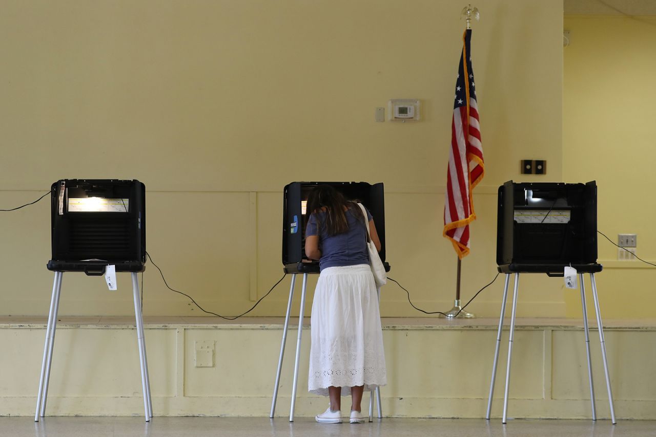 Gissele Riberiro fills out her ballot as she votes at the Legion Park polling place on Tuesday in Miami. 