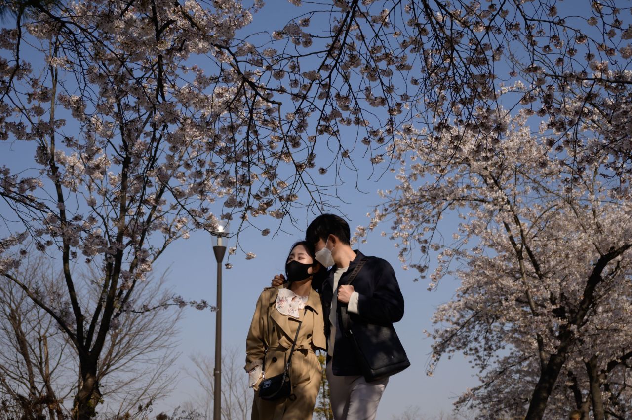 A couple walks in the Yeouido district of Seoul, South Korea, on April 5.