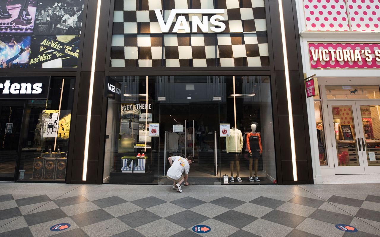 An employee locks a Vans Inc footwear store at the Westgate shopping centre in Oxford on Wednesday, May 27. Retail outlets can reopen starting June 15 as long as they comply with government coronavirus-secure guidelines.