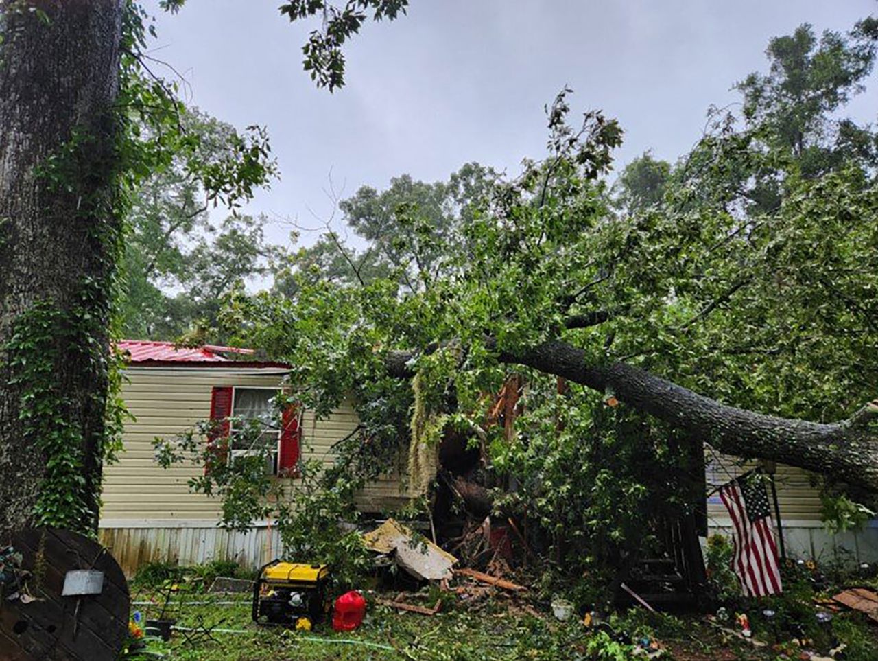 A fallen tree is seen on a mobile home in Fanning Springs, Florida, where a 13-year-old boy was killed on Monday morning. 