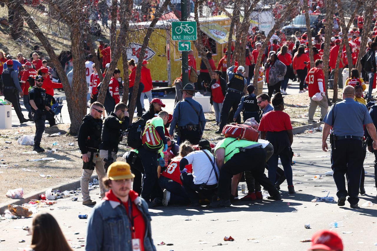 Law enforcement and medical personnel gather around an injured person following the shooting in Kansas City, Missouri, on February 14. 