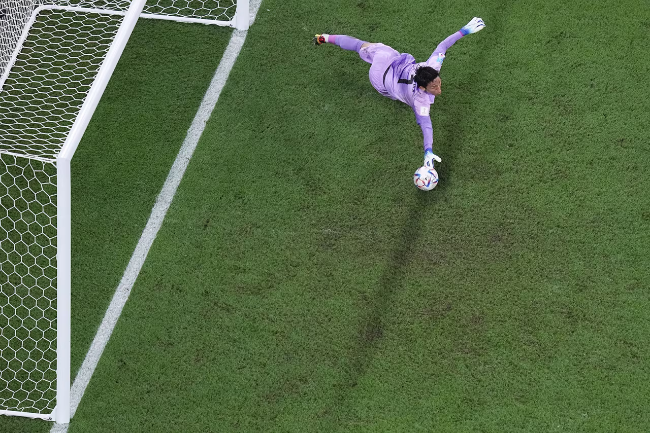 Kim Seung-gyu stretches to save a shot during the same match.