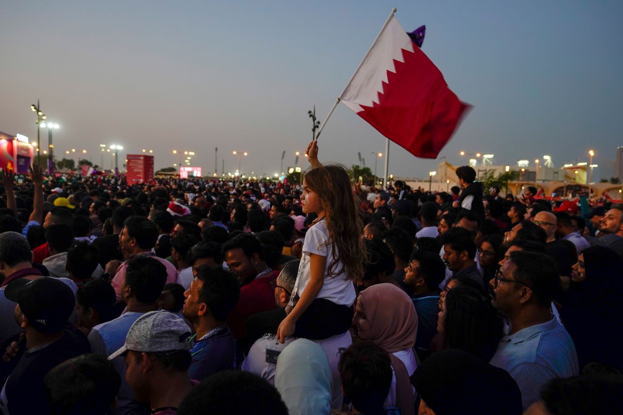 A girl waves a Qatari flag during the opening ceremony for the World Cup prior to the match between Qatar and Ecuador, in Doha, Qatar on November 20.