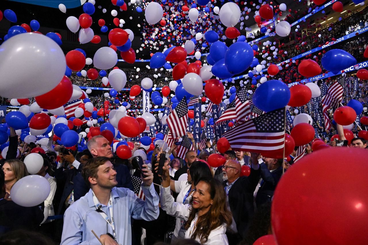 Balloons fall from the ceiling of Chicago's United Center at the end of the convention on Thursday.