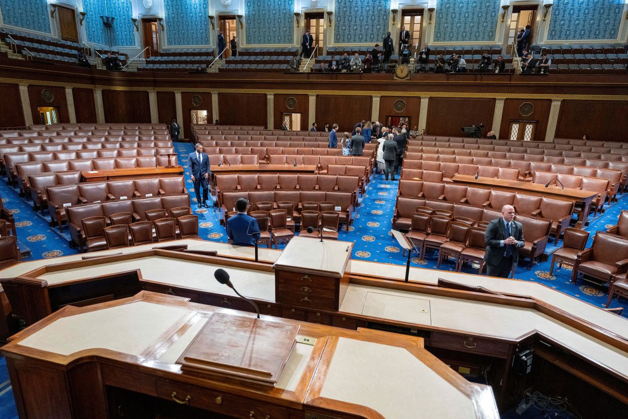 President Joe Biden, back center, departs a nearly empty House chamber after delivering the State of the Union address.