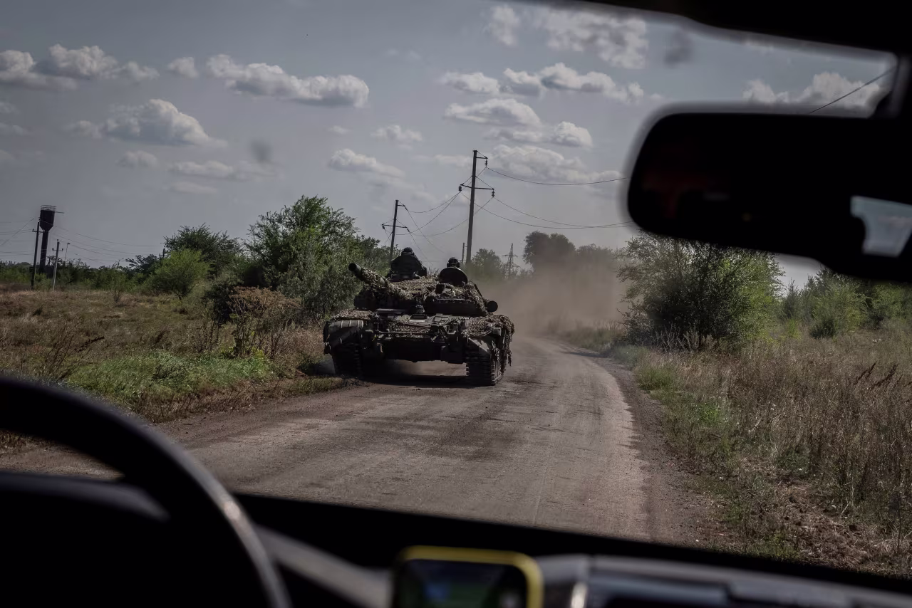 Ukrainian servicemen ride atop a tank near the village of Robotyne, Ukraine, on August 25. 