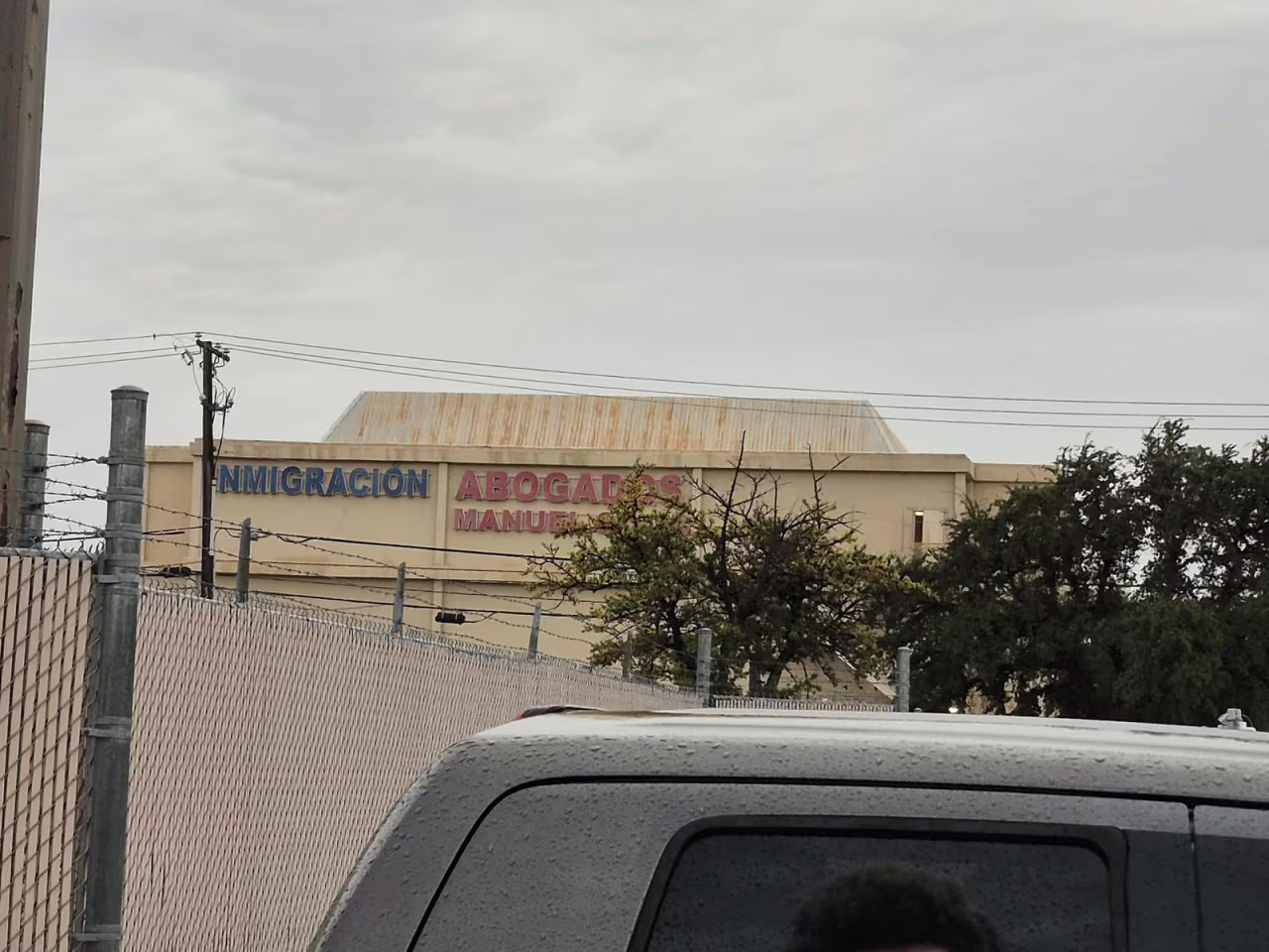 The fence where Shane Reynolds took cover Wednesday as gunshots rang out outside the ICE building in Dallas.