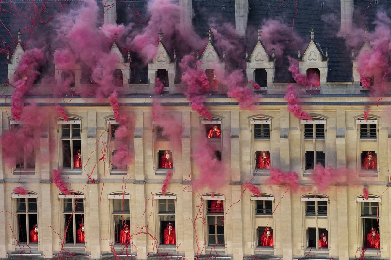 Smoke billows near windows as performers participate during the opening ceremony today.