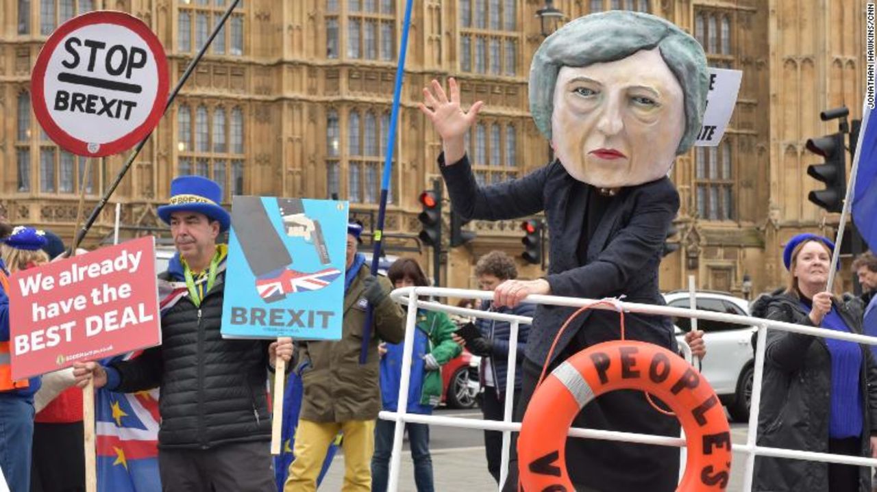 A giant model of Theresa May sails past with a liferaft for a "People's vote."