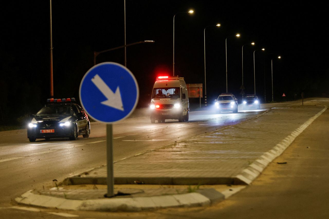 An ambulance believed to be carrying released hostages drives near the Israel-Gaza border early Sunday, local time.