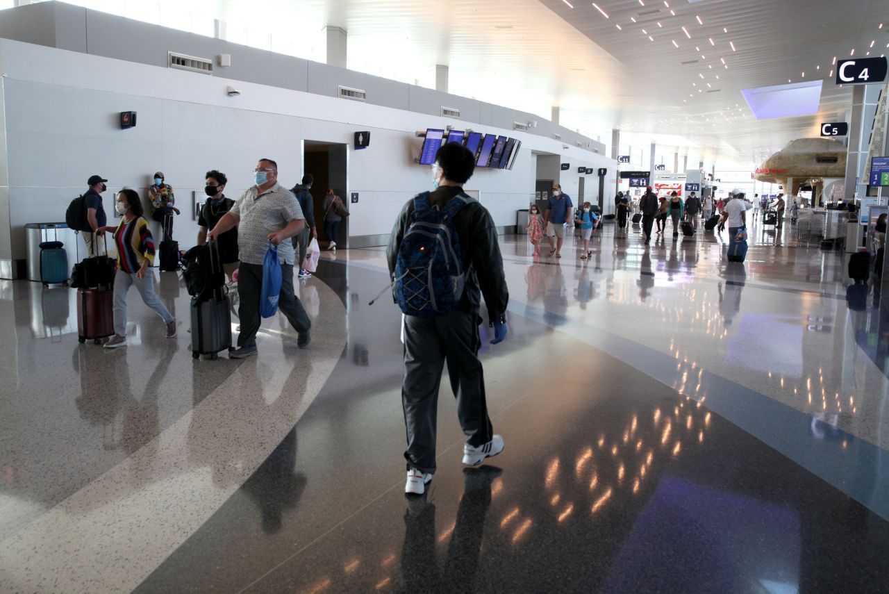 Passengers walk through the United Airlines terminal at George Bush Intercontinental Airport on May 11 in Houston. 