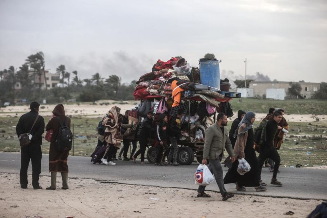 Palestinians carry their belongings as they leave their homes and flee from Khan Younis, Gaza on Tuesday.