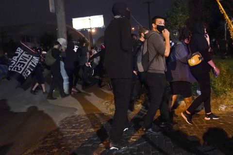 Protesters react to gunfire on Wednesday night in Louisville, Kentucky.