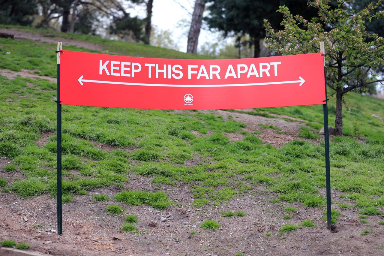 A social distance guideline sign stating "Keep This Far Apart" is seen in Fort Greene Park on April 23, in the Clinton Hill neighborhood of the Brooklyn borough of New York City. 