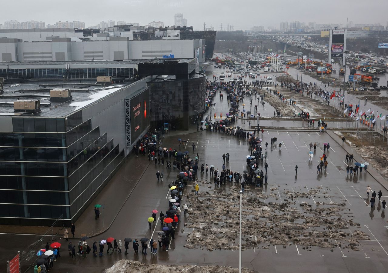 People line up at a makeshift memorial outside Crocus City Hall near Moscow on March 24.