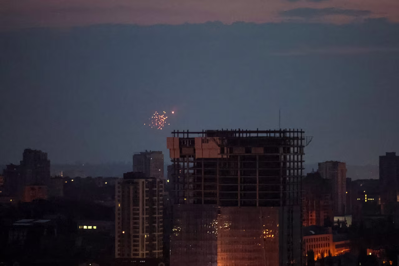 An explosion of a drone is seen in the sky over the city during a Russian drone strike in Kyiv, Ukraine on June 20.