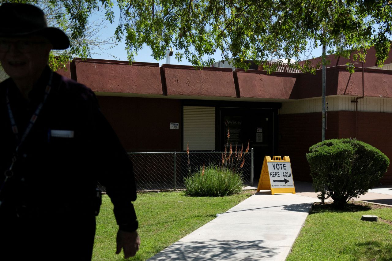 A man walks by a polling place during primary elections in Phoenix on March 19.